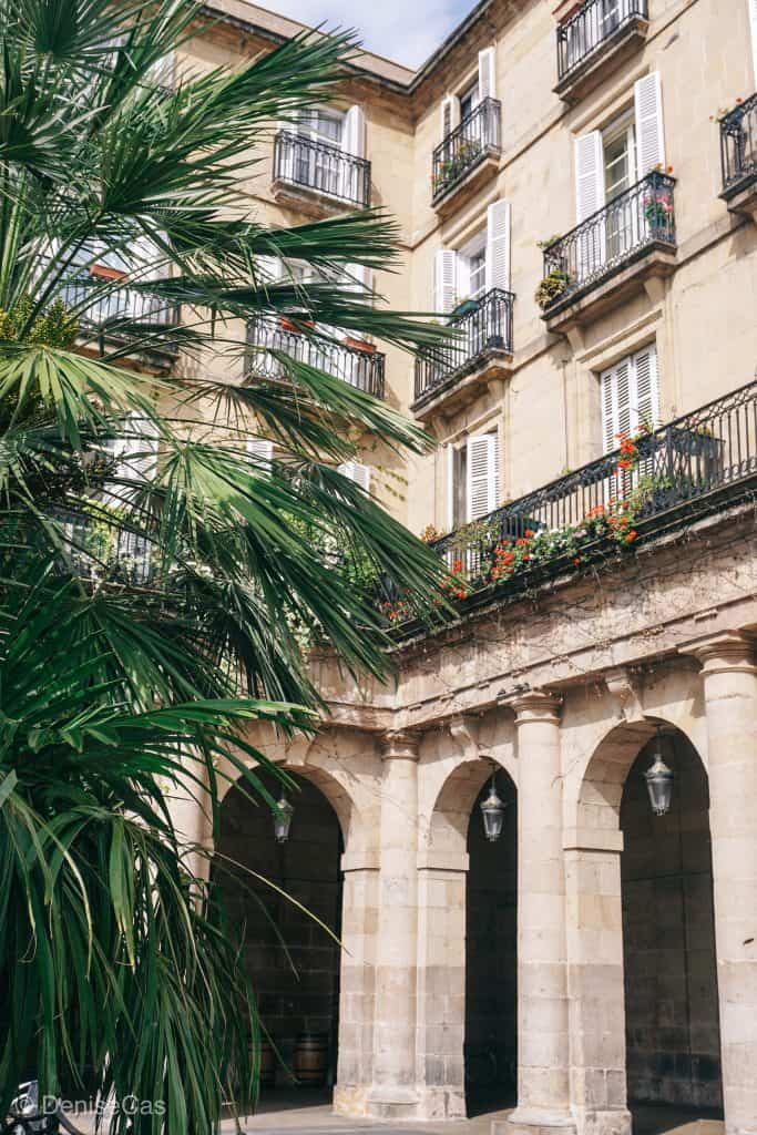 a building with a palm tree in front of it.