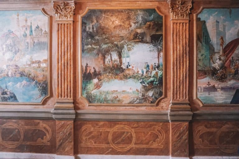A weekend guide to Georgia featuring a wall with paintings and a clock.