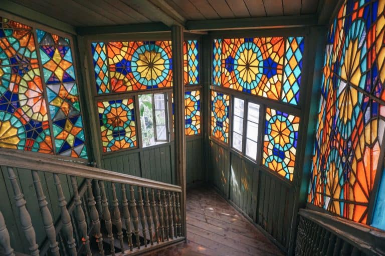 A weekend guide to Georgia featuring a room with stained glass windows and railings.