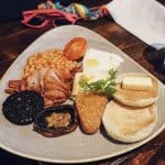 a plate of food on a wooden table.