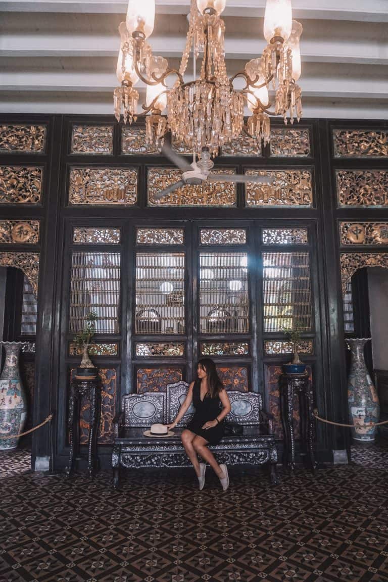 a woman sitting on a bench in Penang.