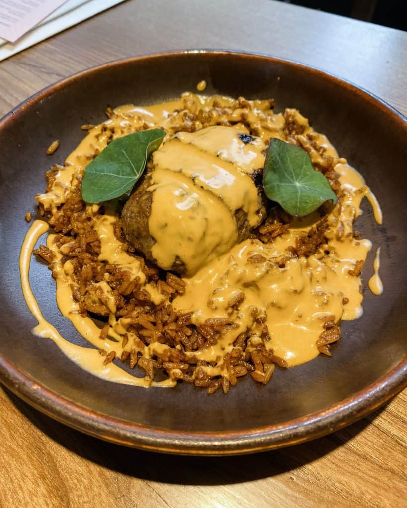 a plate of food on a wooden table.
