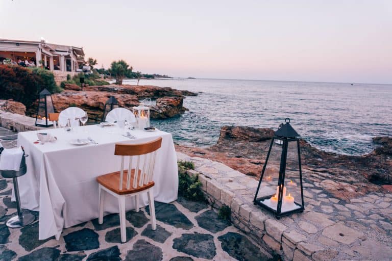 A dinner table set up by the ocean at Creta Maris Beach Resort in Crete.
