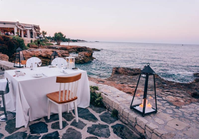 A dinner table set up by the ocean at Creta Maris Beach Resort in Crete.