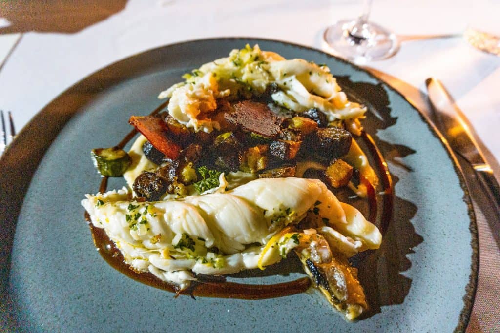 A plate of food on a table with silverware at Creta Maris Beach Resort in Crete, Greece.