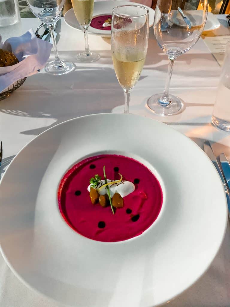 A plate of food and glasses of wine on a table at Creta Maris Beach Resort.