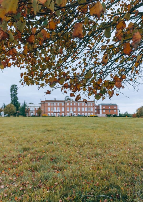 An English countryside field with a building in the background, perfect for a UK weekend staycation at Four Seasons Hampshire.