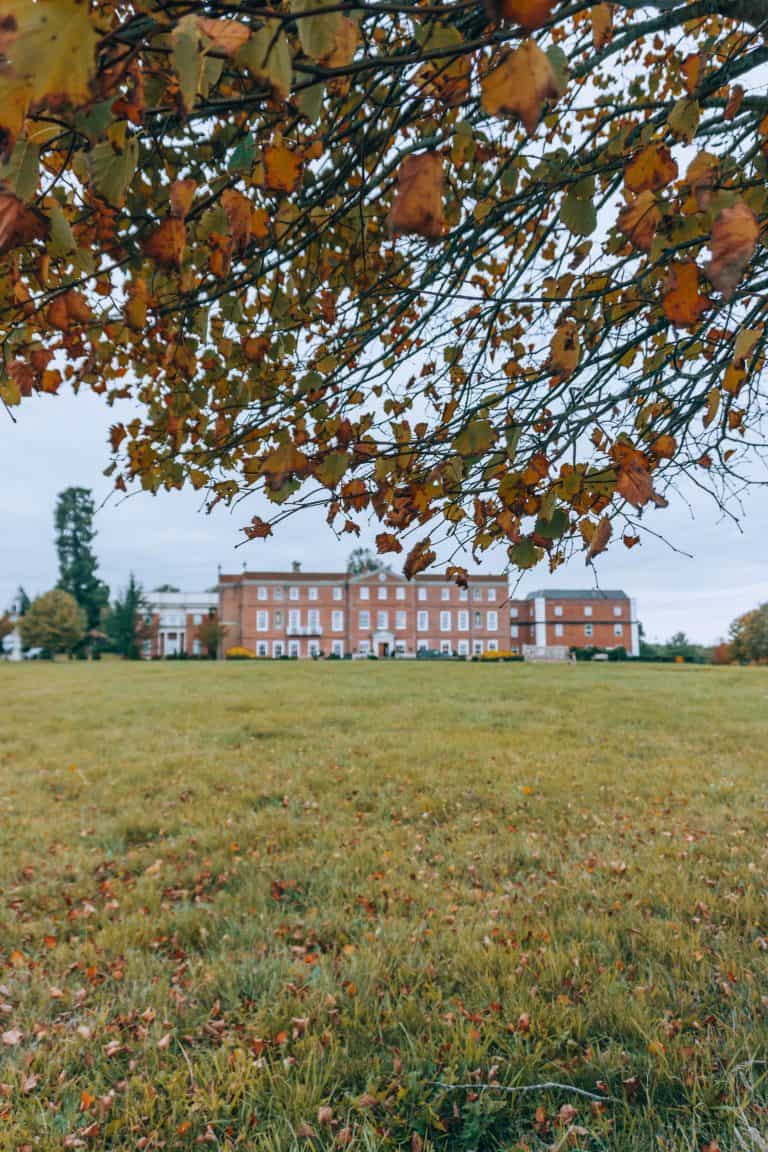 An English countryside field with a building in the background, perfect for a UK weekend staycation at Four Seasons Hampshire.