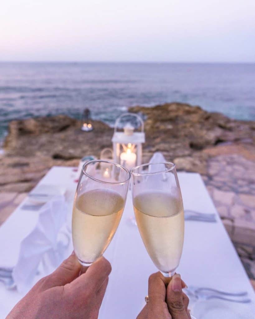 a couple of people holding glasses of wine.