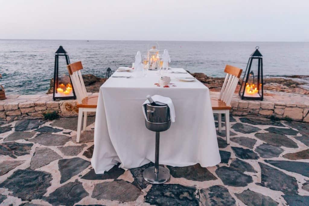 a table with a white table cloth and some candles.