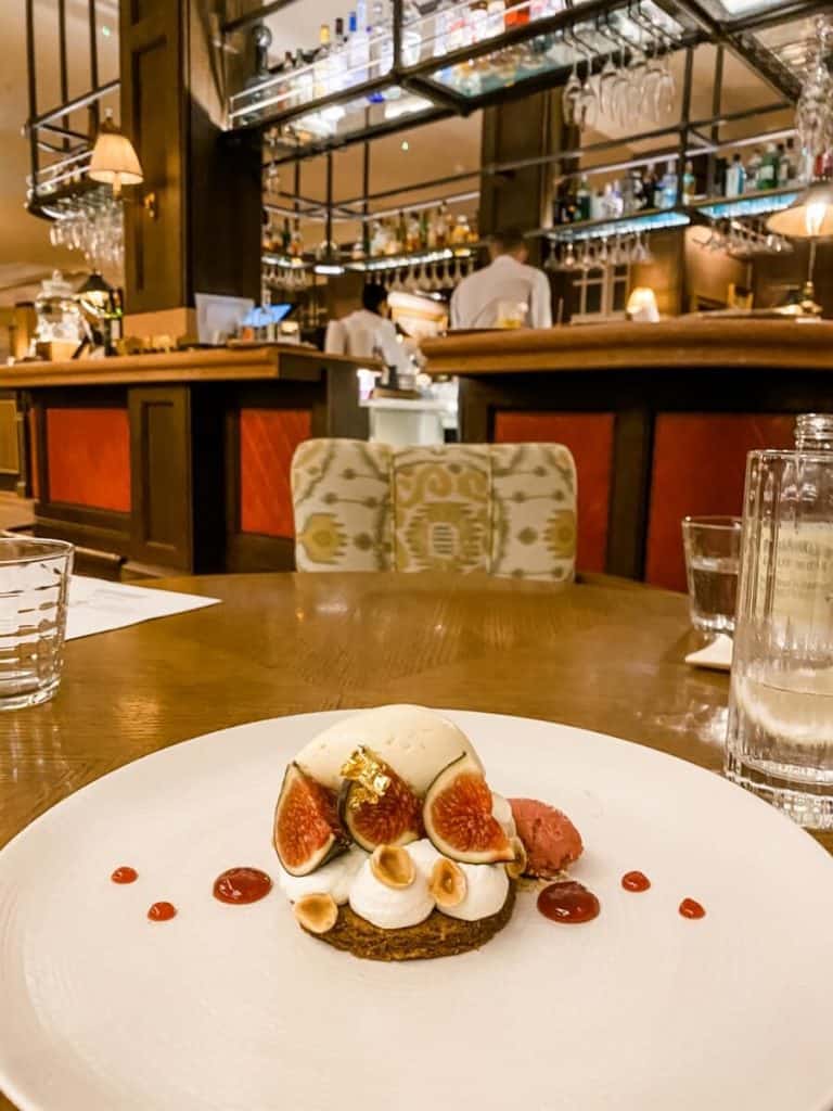 a white plate topped with food on top of a wooden table.